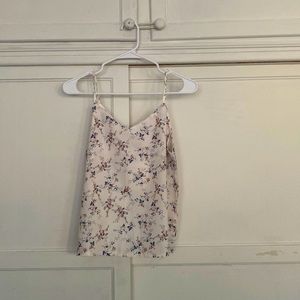 Selling cute white top with flowers printed on.